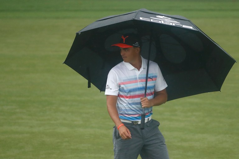 CHARLOTTE, NC - AUGUST 08:  Rickie Fowler of the United States walks up a fairway under an umbrella during a practice round prior to the 2017 PGA Championship at Quail Hollow Club on August 8, 2017 in Charlotte, North Carolina.  (Photo by Sam Greenwood/Getty Images)