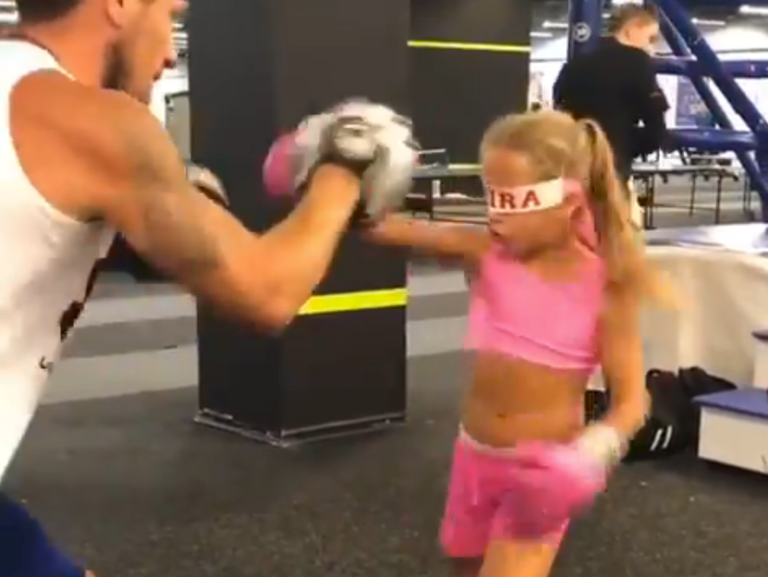 Little girl practices boxing blindfolded.