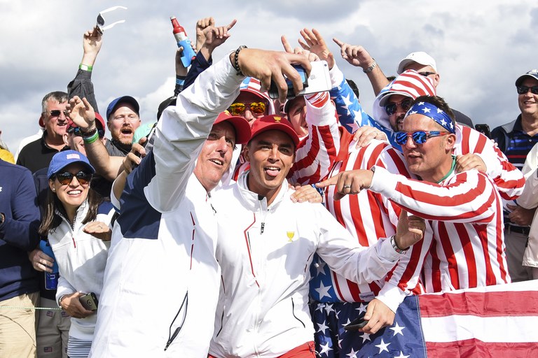 JERSEY CITY, NJ - SEPTEMBER 30:  Phil Mickelson and Rickie Fowler of the U.S. Team take a selfie with fans on the eighth hole during Saturday afternoon Four-Ball matches in the third round of the Presidents Cup at Liberty National Golf Club on September 30, 2017, in Jersey City, New Jersey. (Photo by Keyur Khamar/PGA TOUR)