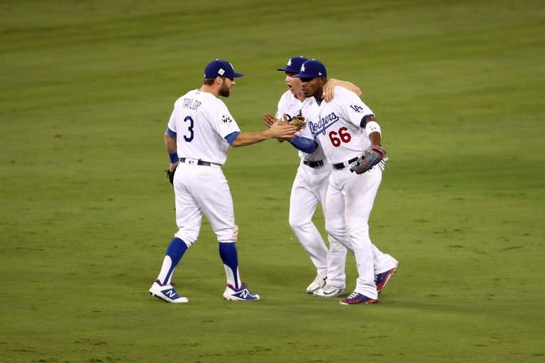 LOS ANGELES, CA - OCTOBER 31:  Joc Pederson #31 of the Los Angeles Dodgers celebrates with Yasiel Puig #66 and Chris Taylor #3 after defeating the Houston Astros 3-1 in game six of the 2017 World Series at Dodger Stadium on October 31, 2017 in Los Angeles, California.  (Photo by Christian Petersen/Getty Images)