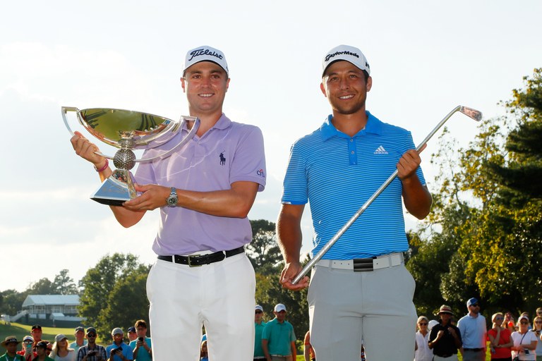 ATLANTA, GA - SEPTEMBER 24:  Justin Thomas of the United States celebrates with the trophy on the 18th green after winning the FedExCup and second in the TOUR Championship as Xander Schauffele celebrates with the Calamity Jane trophy for winning the TOUR Championship after the final round at East Lake Golf Club on September 24, 2017 in Atlanta, Georgia.  (Photo by Kevin C. Cox/Getty Images)