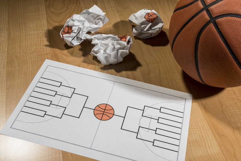 Trying to fill out college basketball tournament bracket on paper