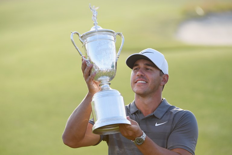 Brooks Koepka celebrates with the U.S. Open Championship trophy after winning the 2018 U.S. Open at Shinnecock Hills Golf Club.