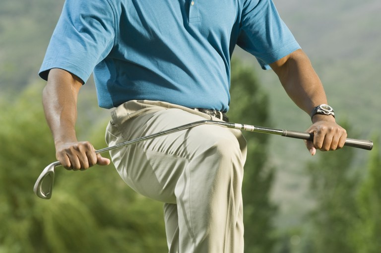 Golfer breaking golf club