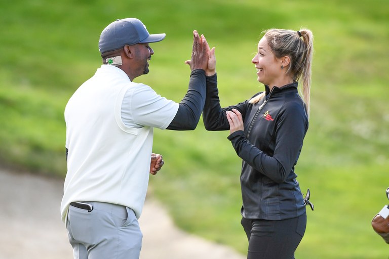 Alfonso Ribeiro and Kira Kazantsev high five on the 18th hole during the first round of the 2019 AT&T Pebble Beach Pro-Am.